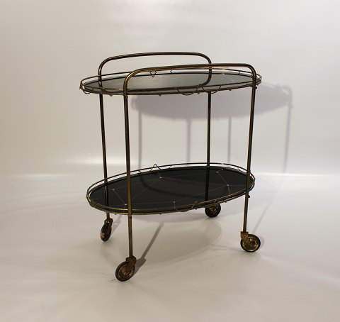 Tray table with patterned black plates and frame of brass from the 1930s. 
5000m2 showroom.