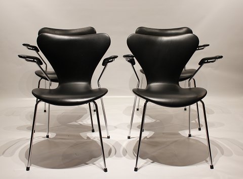 Et sæt af fire syver stole, model 3207, med armlæn i sort savanne læder af Arne Jacobsen og Fritz Hansen. 5000m2 udstilling.