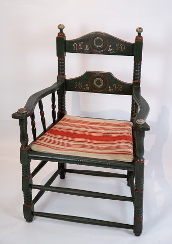 Antique green painted armchair upholstered with striped fabric from 1872.
5000m2 showroom.
