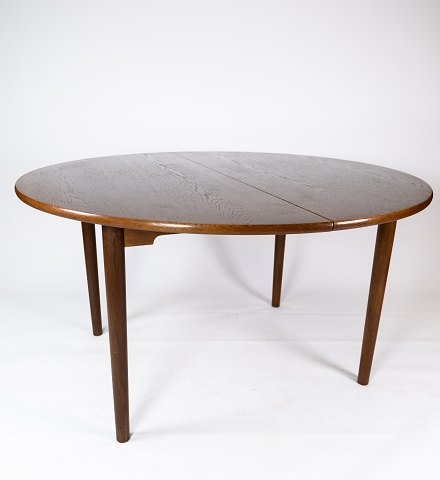 Dining table in dark oak of danish design from the 1960s. 
5000m2 showroom.
