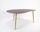 Coffee table with dark grey laminate top and legs of oak by Via Copenhagen.
5000m2 showroom.