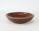Ceramic bowl in 
dark red no.: 2650 by Niels Thorson for Aluminia.
5000m2 showroom.