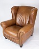 Stor hvilestole/øreklapstol i cognacfarvet læder. 
5000m2 udstilling.
