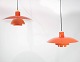 To orange højglans PH4 pendler designet af Poul Henningsen og fremstillet hos Louis Poulsen i 1950erne.5000m2 udstilling.